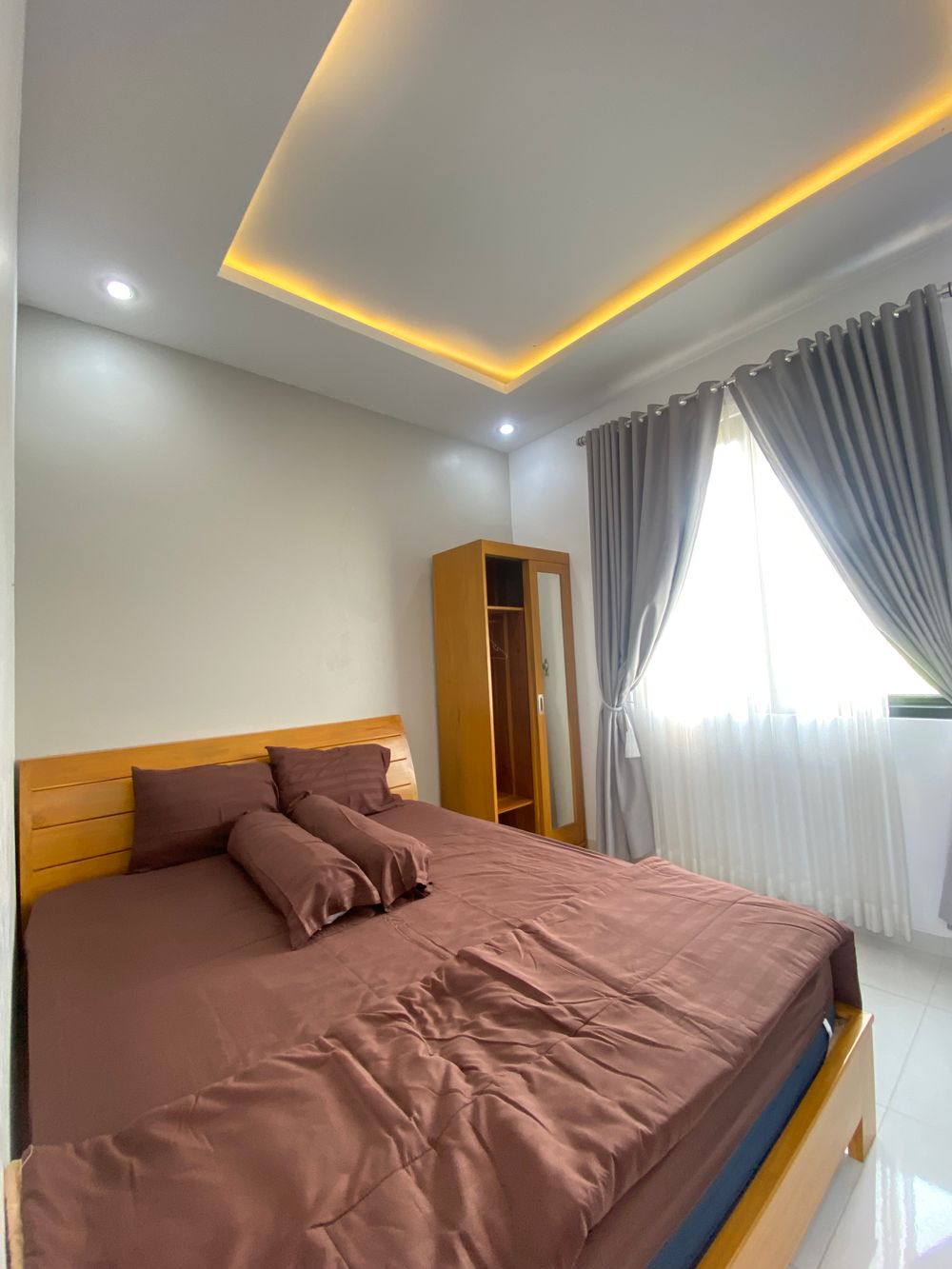 Warmly lit bedroom with tailored bedding