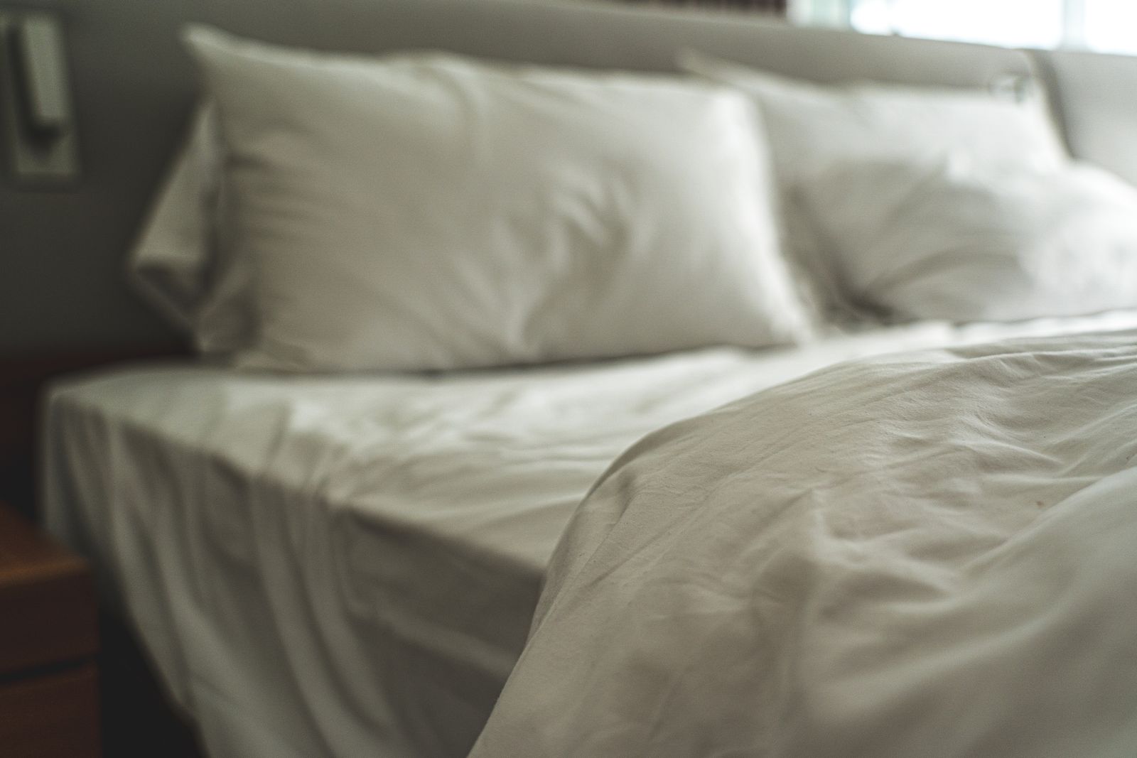 Bedroom with crisp white linen in a furnished apartment